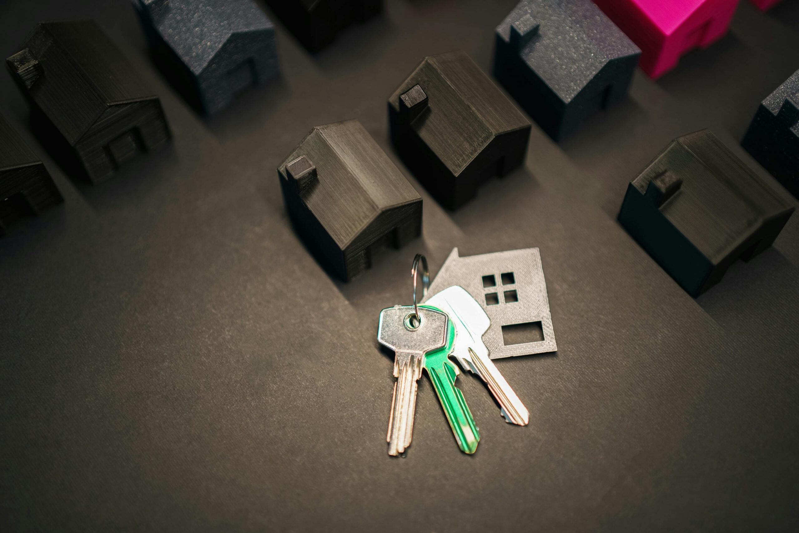 Miniature house models and keys symbolize real estate investment and housing market.