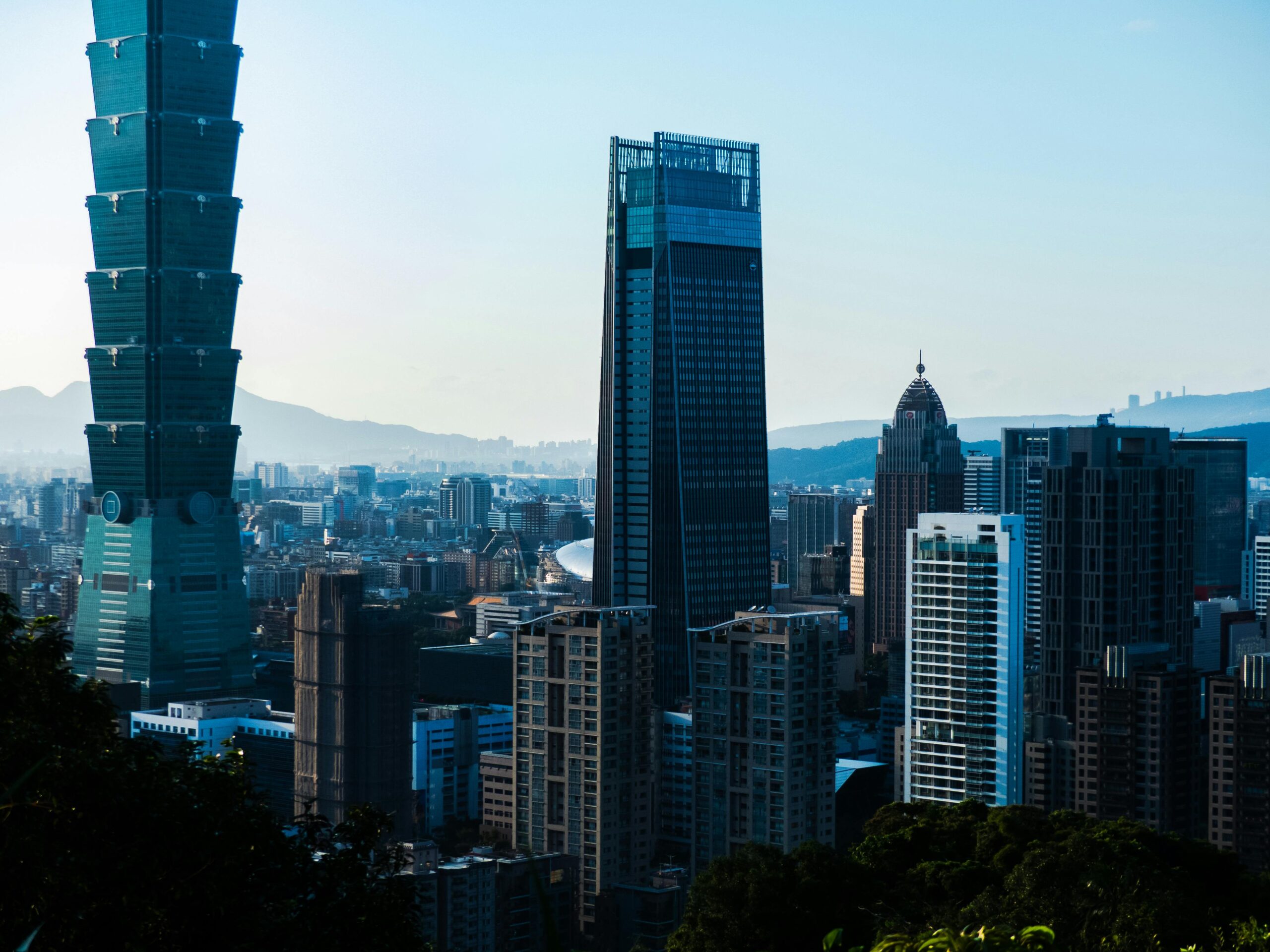 A breathtaking view of Taipei city skyline featuring Taipei 101 and modern architecture during sunrise.